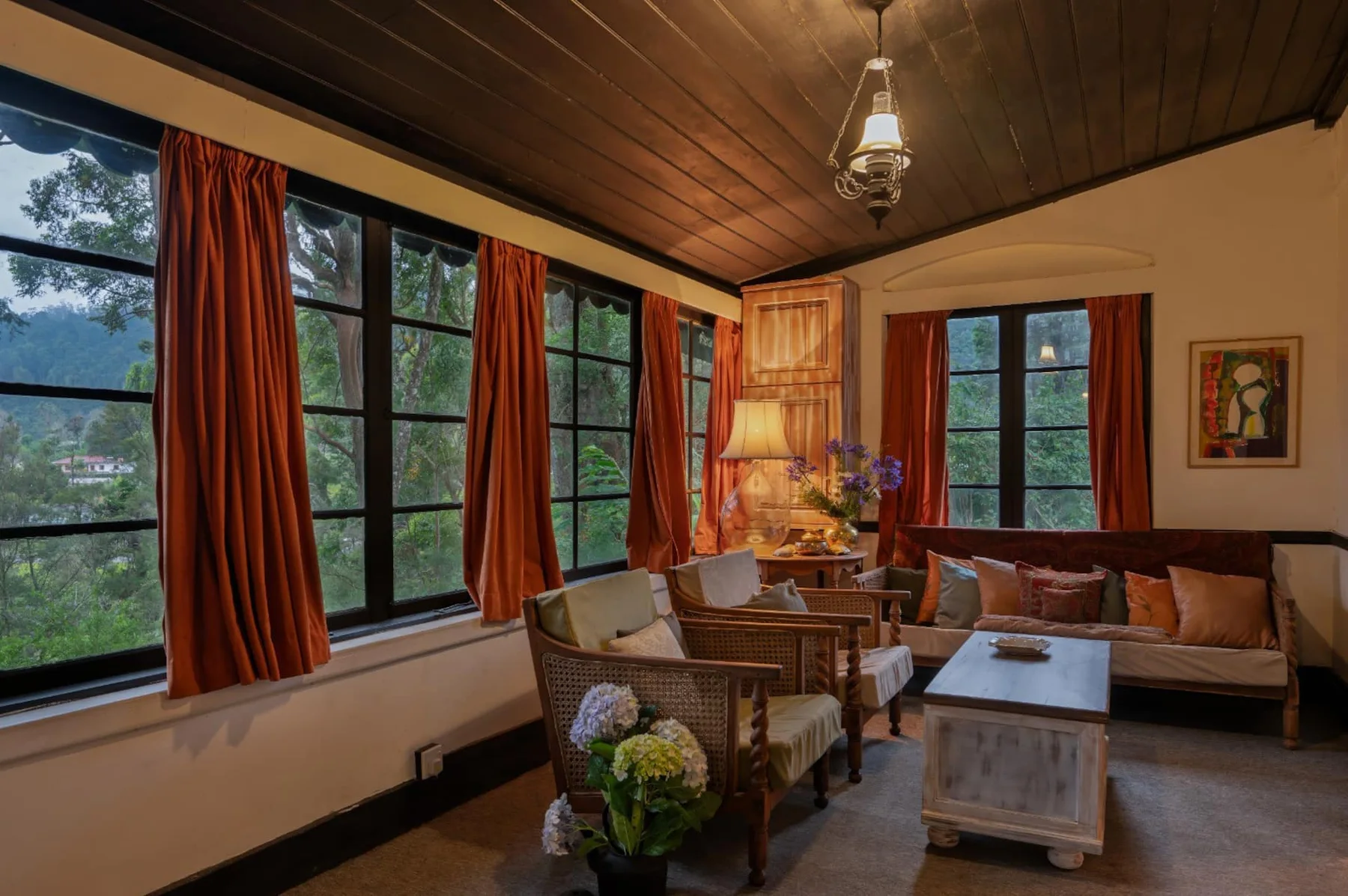 The veranda with warm timber ceilings and garden-facing windows